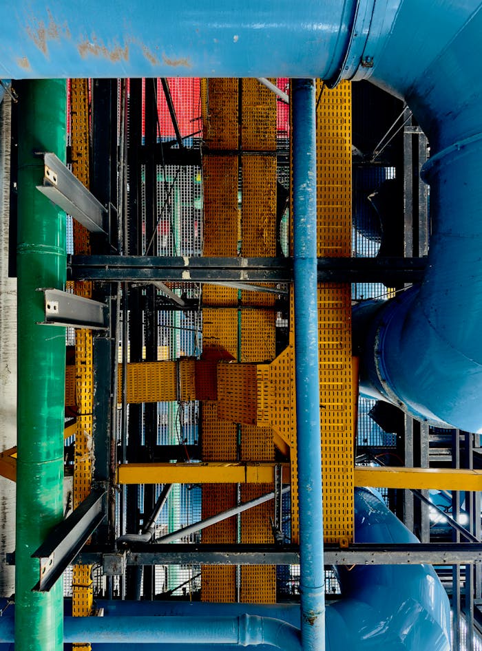 services-04 Vivid industrial scene with colorful pipes and metal structures.