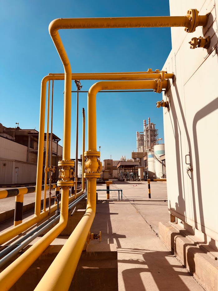 services-01 Yellow gas pipeline with clear blue sky at a Saudi cement factory.